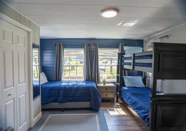 a bedroom with a bed furniture and a flat tv screen