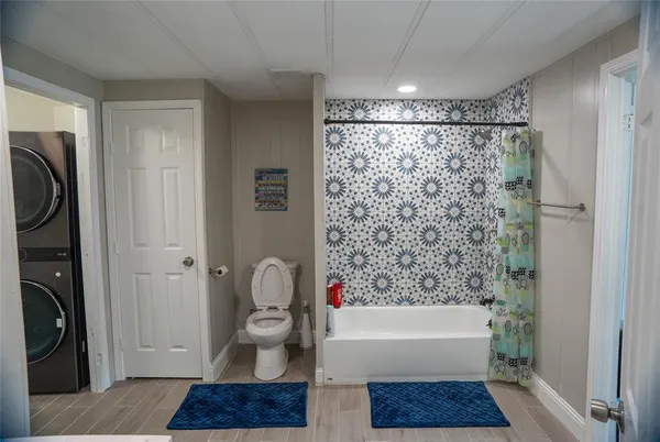a bathroom with a bathtub a toilet and a shower