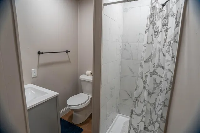 a bathroom with a toilet and a shower