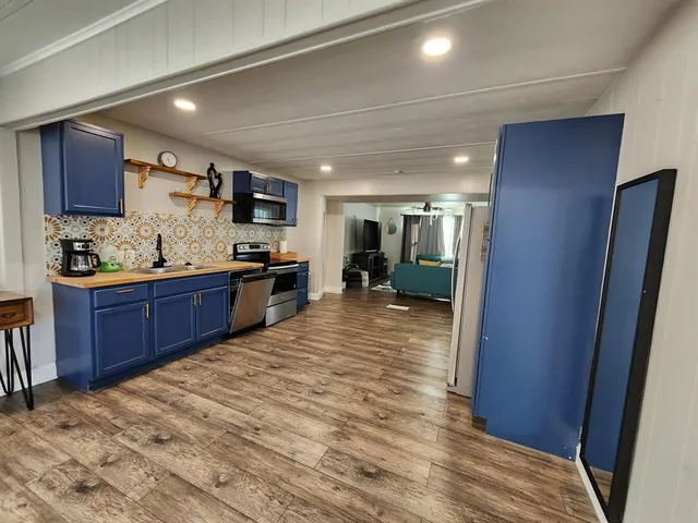 a kitchen with stainless steel appliances granite countertop a refrigerator and a sink