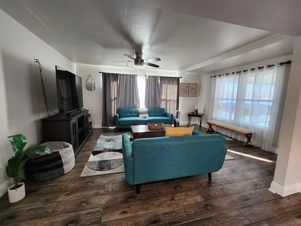 a living room with furniture and a flat screen tv
