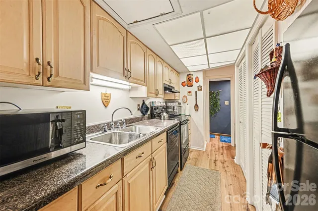 a kitchen with stainless steel appliances granite countertop a sink stove and cabinets