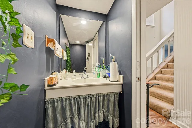 a bathroom with a sink vanity and mirror