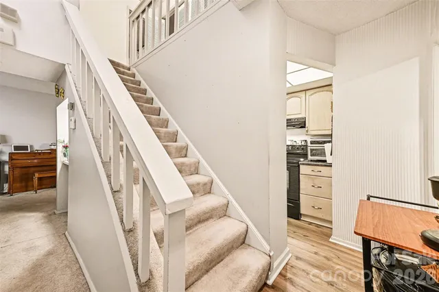 a living room with furniture and stairs