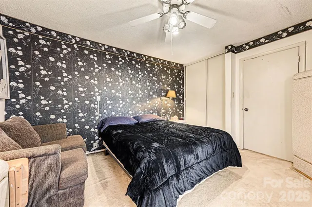 a bedroom with bed and a chandelier