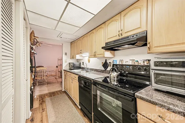 a kitchen with stainless steel appliances granite countertop a stove and a sink