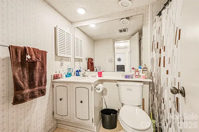 a kitchen with a sink a toilet and a window