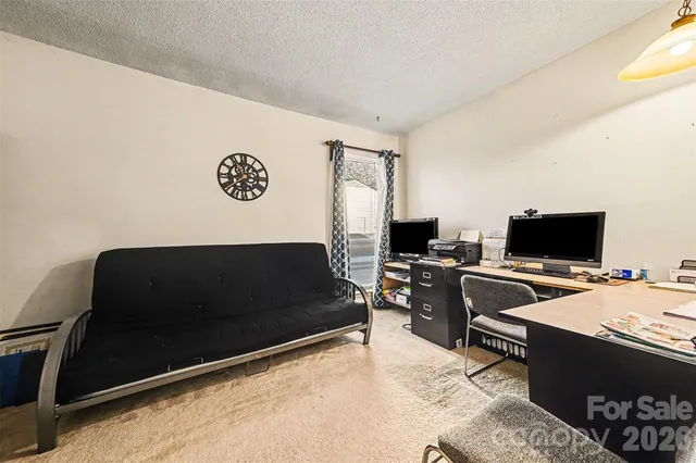 a view of a livingroom with workspace and a couch