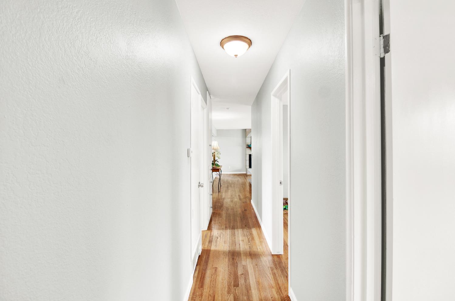 1530 Morene Way Modesto, CA 95355 - Photo 14 of 38 a view of a hallway with wooden floor