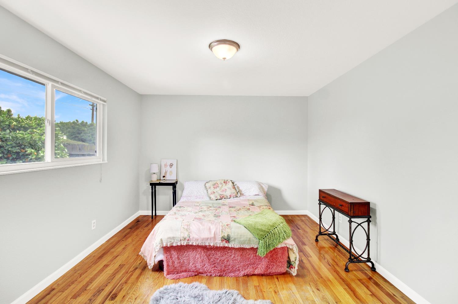 1530 Morene Way Modesto, CA 95355 - Photo 15 of 38 a bedroom with a bed and a painting on the wall