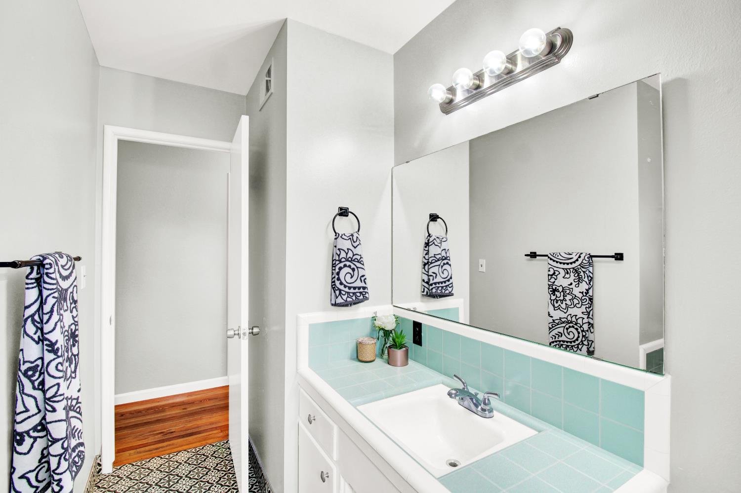 1530 Morene Way Modesto, CA 95355 - Photo 19 of 38 a bathroom with a sink a mirror and a bathtub