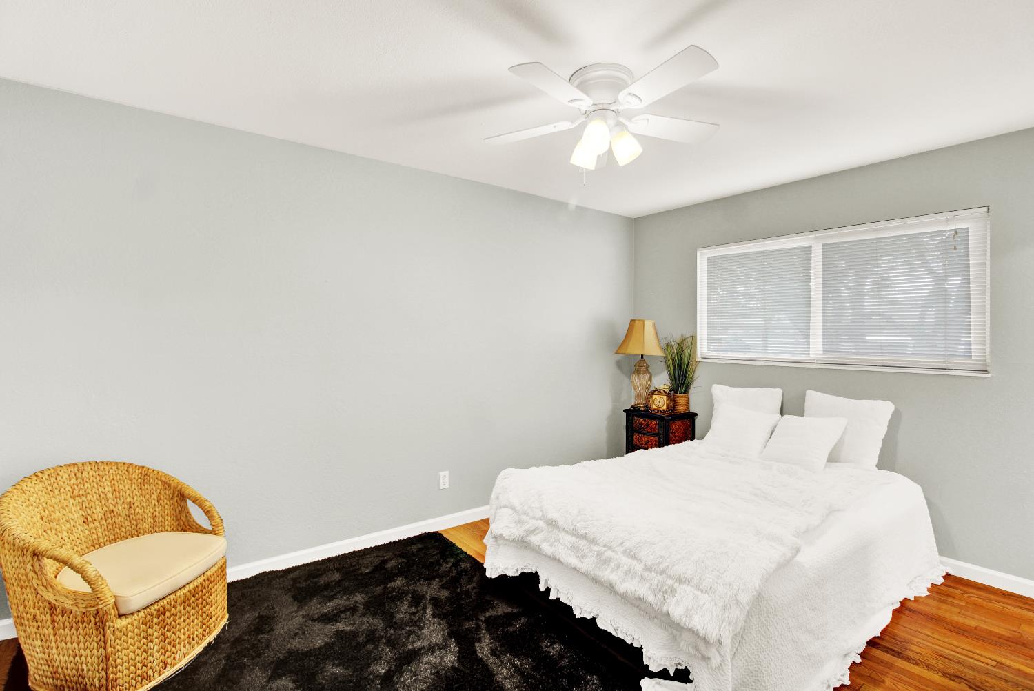 1530 Morene Way Modesto, CA 95355 - Photo 24 of 38 a bedroom with a bed and a chandelier