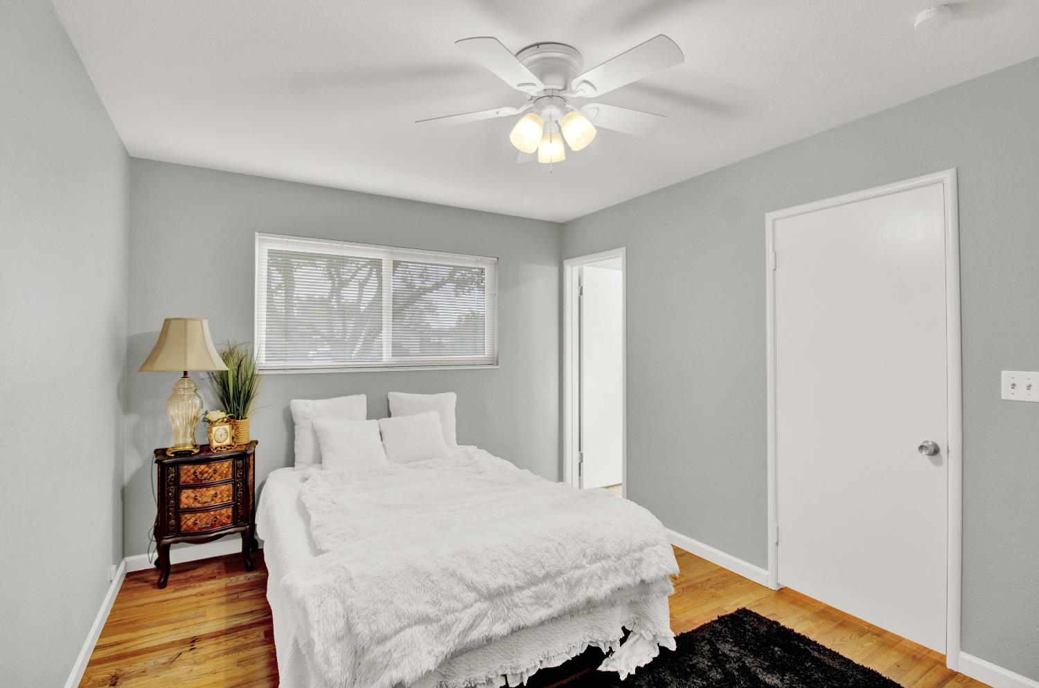 1530 Morene Way Modesto, CA 95355 - Photo 25 of 38 a bedroom with a bed and a chandelier