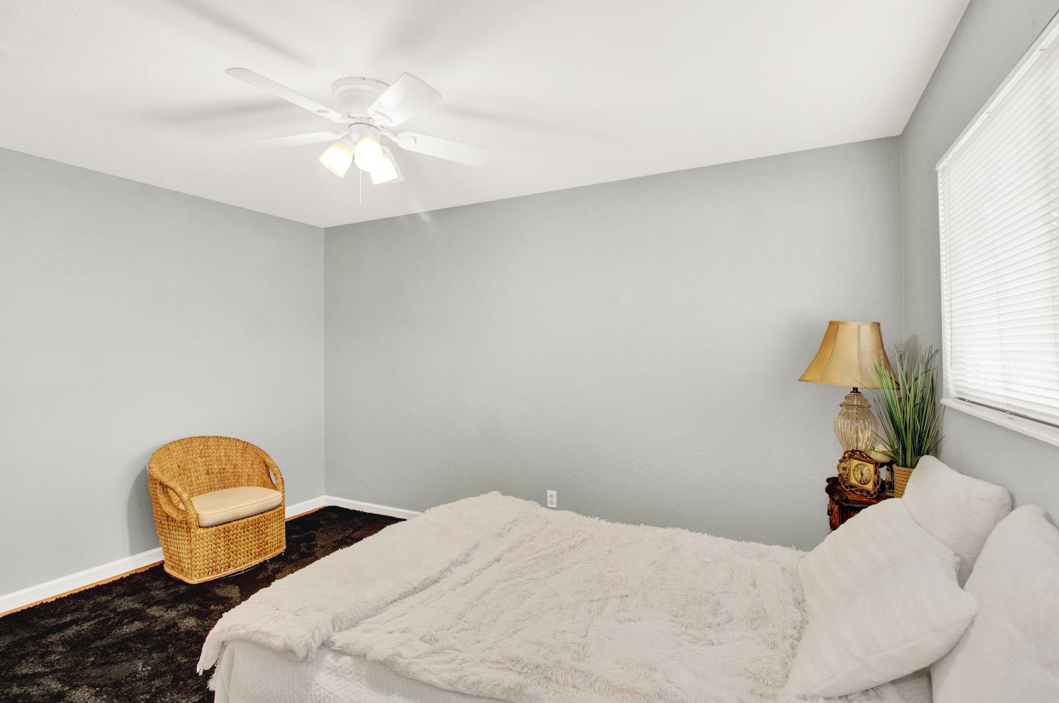 1530 Morene Way Modesto, CA 95355 - Photo 26 of 38 a bedroom with a bed and a chandelier