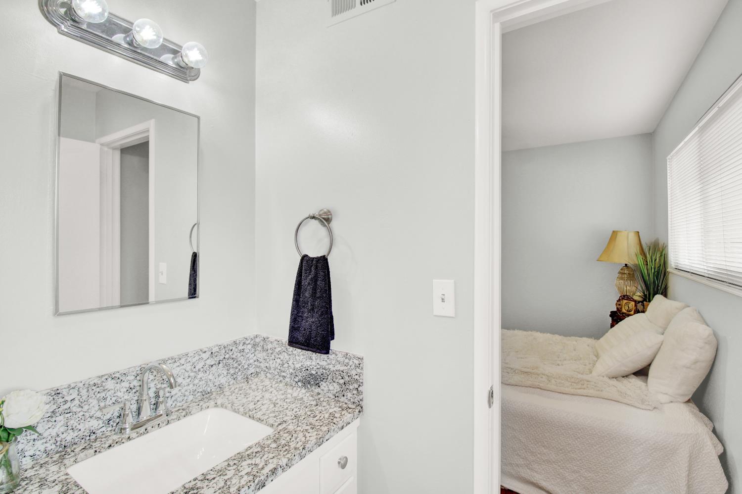 1530 Morene Way Modesto, CA 95355 - Photo 29 of 38 a bathroom with a granite countertop sink and a mirror
