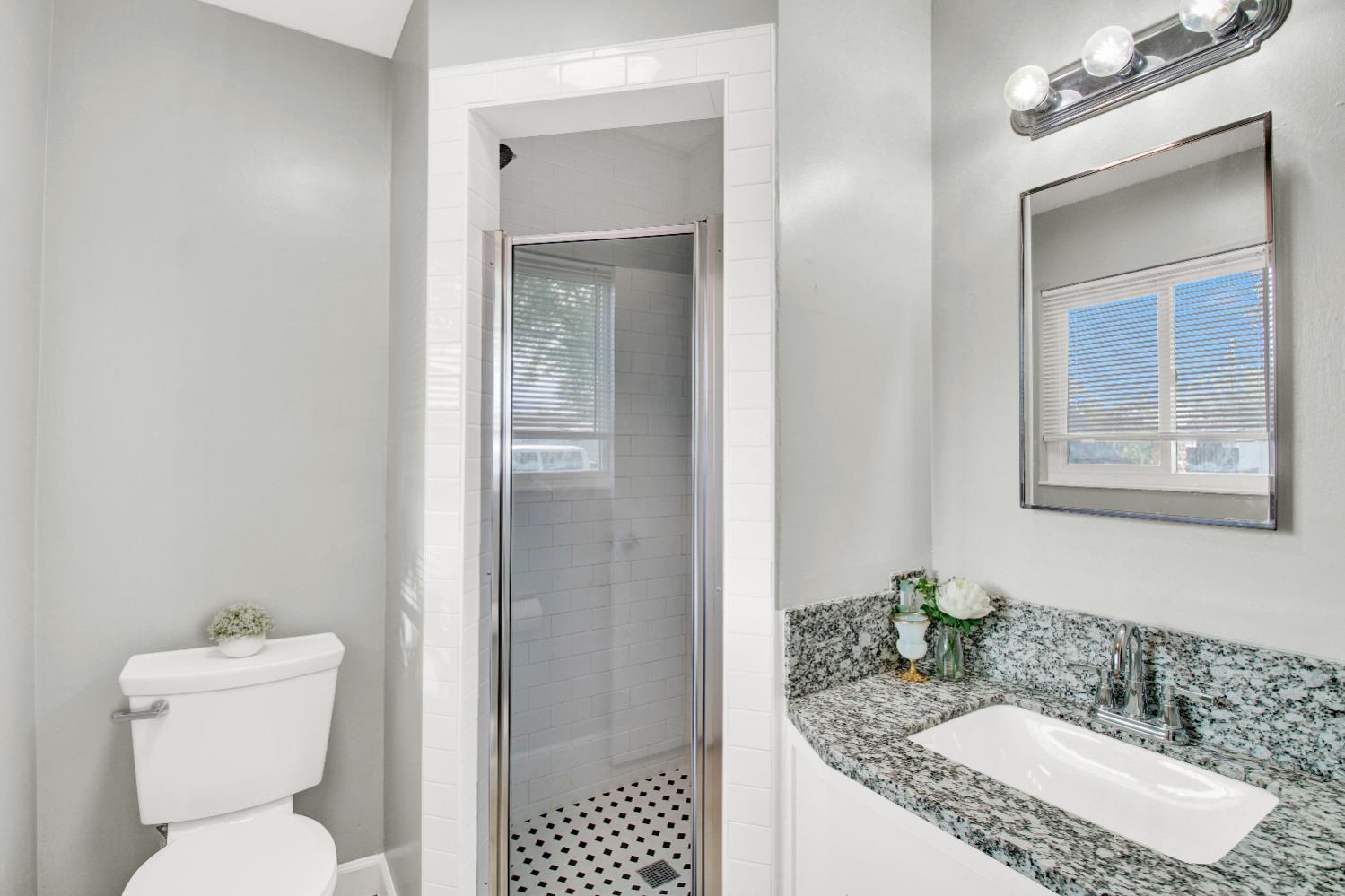 1530 Morene Way Modesto, CA 95355 - Photo 30 of 38 a bathroom with a granite countertop sink mirror vanity and toilet