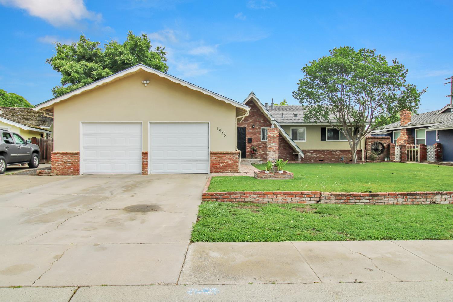 1530 Morene Way Modesto, CA 95355 - Photo 4 of 38 a view of front of house with a yard