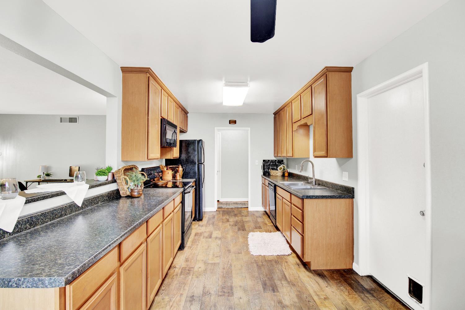 1530 Morene Way Modesto, CA 95355 - Photo 9 of 38 a kitchen with stainless steel appliances granite countertop a stove a sink and a refrigerator
