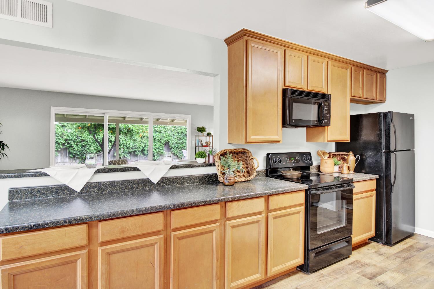 1530 Morene Way Modesto, CA 95355 - Photo 10 of 38 a kitchen with granite countertop a sink stainless steel appliances and cabinets