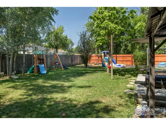 a view of a backyard with a garden and entertaining space