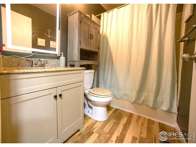 a bathroom with a toilet a sink and a mirror