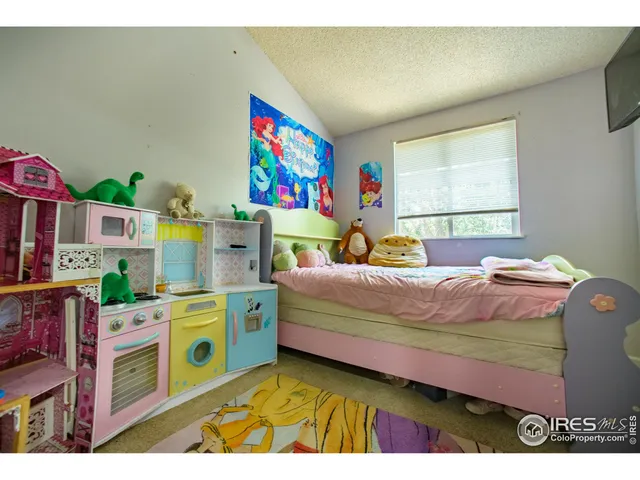 a bedroom with a bed dresser and window