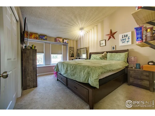 a bedroom with bed and a night stand