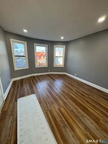 wooden floor in an empty room with a window