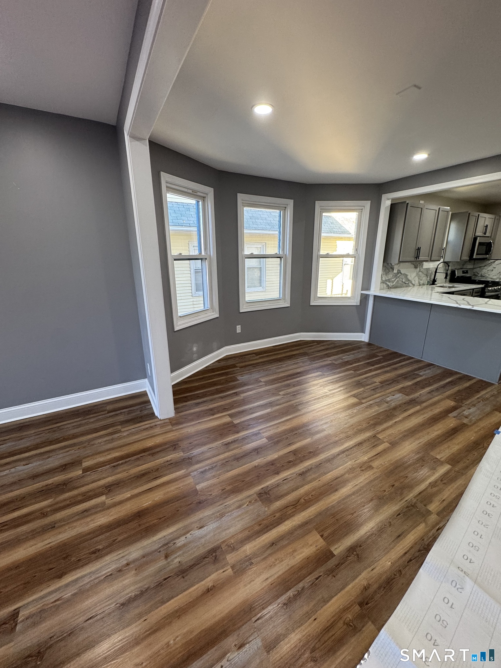 399 Hawley Avenue Bridgeport, CT 06606 - Photo 3 of 11 a view of empty room with wooden floor and fan