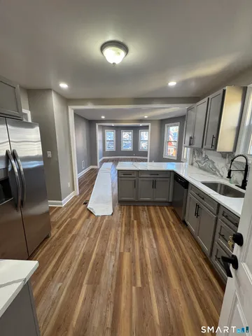a kitchen with sink refrigerator and window