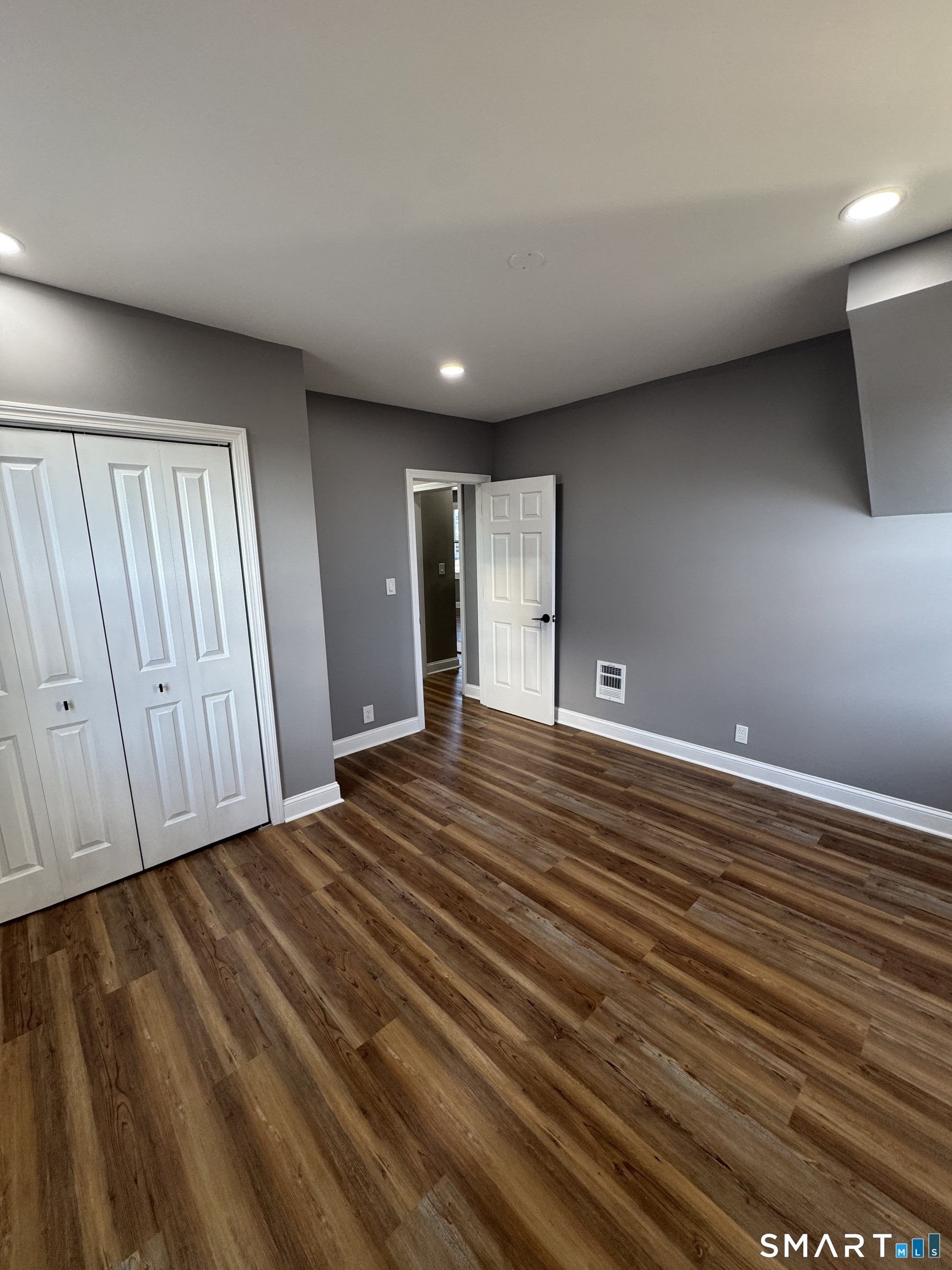 399 Hawley Avenue Bridgeport, CT 06606 - Photo 9 of 11 a view of an empty room with wooden floor