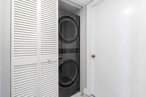 a view of a hallway with washer and dryer