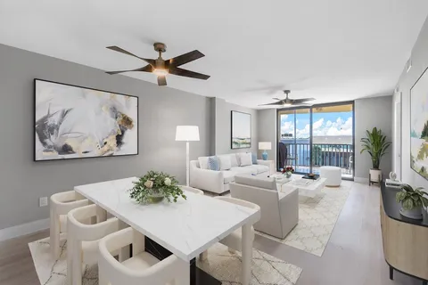 a living room with furniture a chandelier and a table