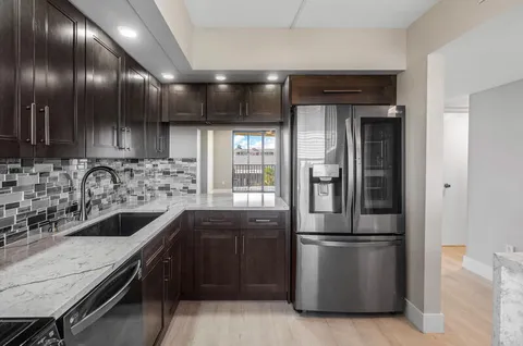 a kitchen with a sink and stainless steel appliances
