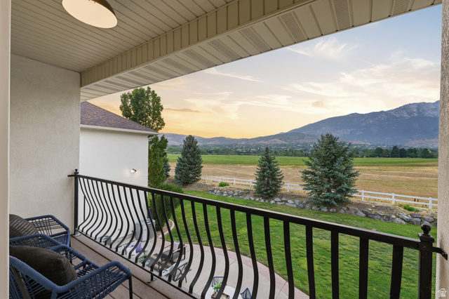 702 Alpine Highway Alpine, UT 84004 - Photo 49 of 83 Balcony featuring a decorative black metal railing, offering expansive scenery with fields and mountains