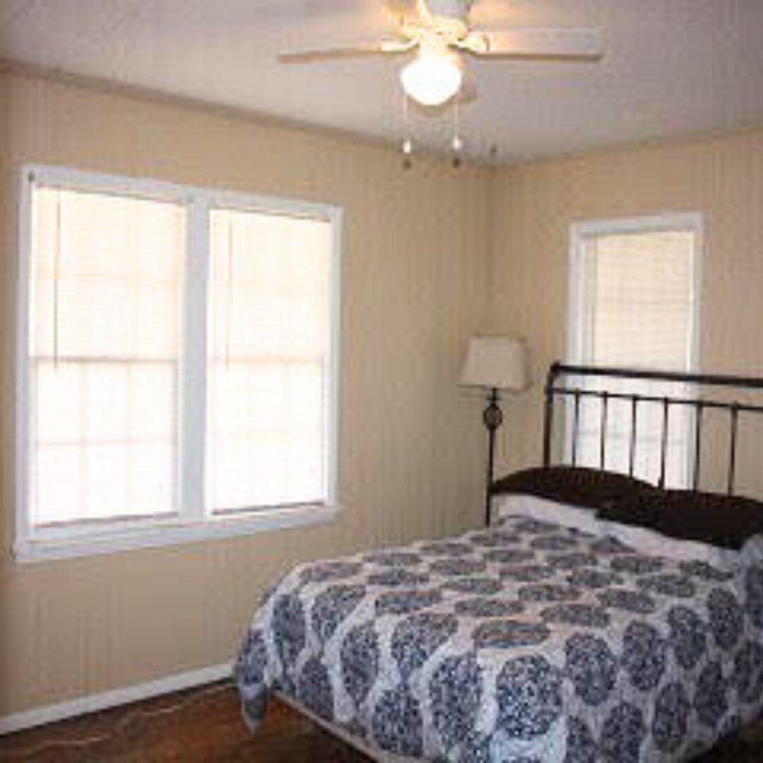 2123 25th Street Lubbock, TX 79411 - Photo 4 of 12 a bedroom with a large bed and a window