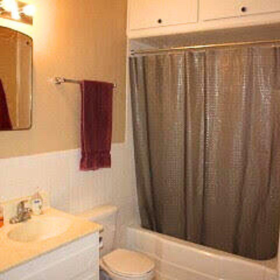 2123 25th Street Lubbock, TX 79411 - Photo 5 of 12 a bathroom with a sink and a mirror