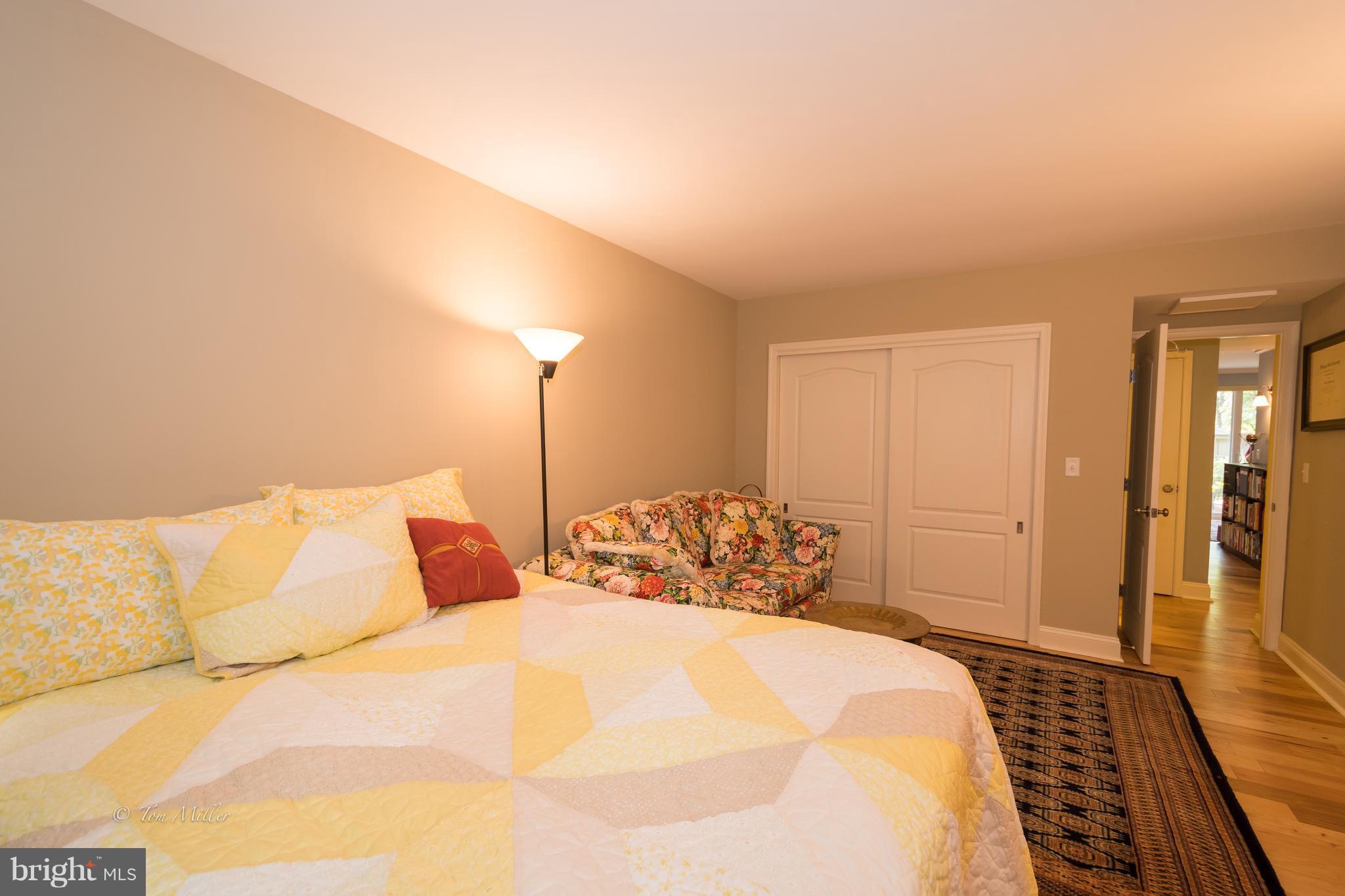 118 Cross Keys Road, Unit R118A Baltimore, MD 21210 - Photo 13 of 20 a bedroom with a bed and wooden floor