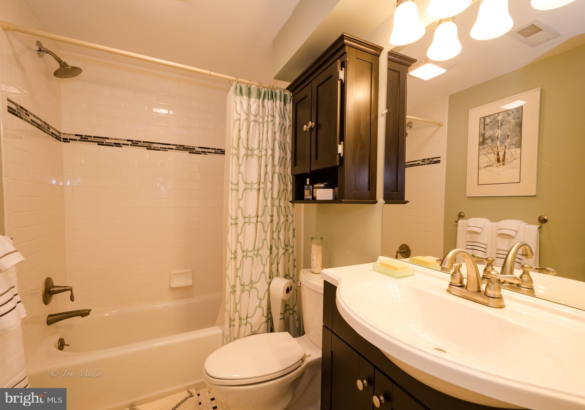 118 Cross Keys Road, Unit R118A Baltimore, MD 21210 - Photo 14 of 20 a bathroom with a sink a toilet and shower