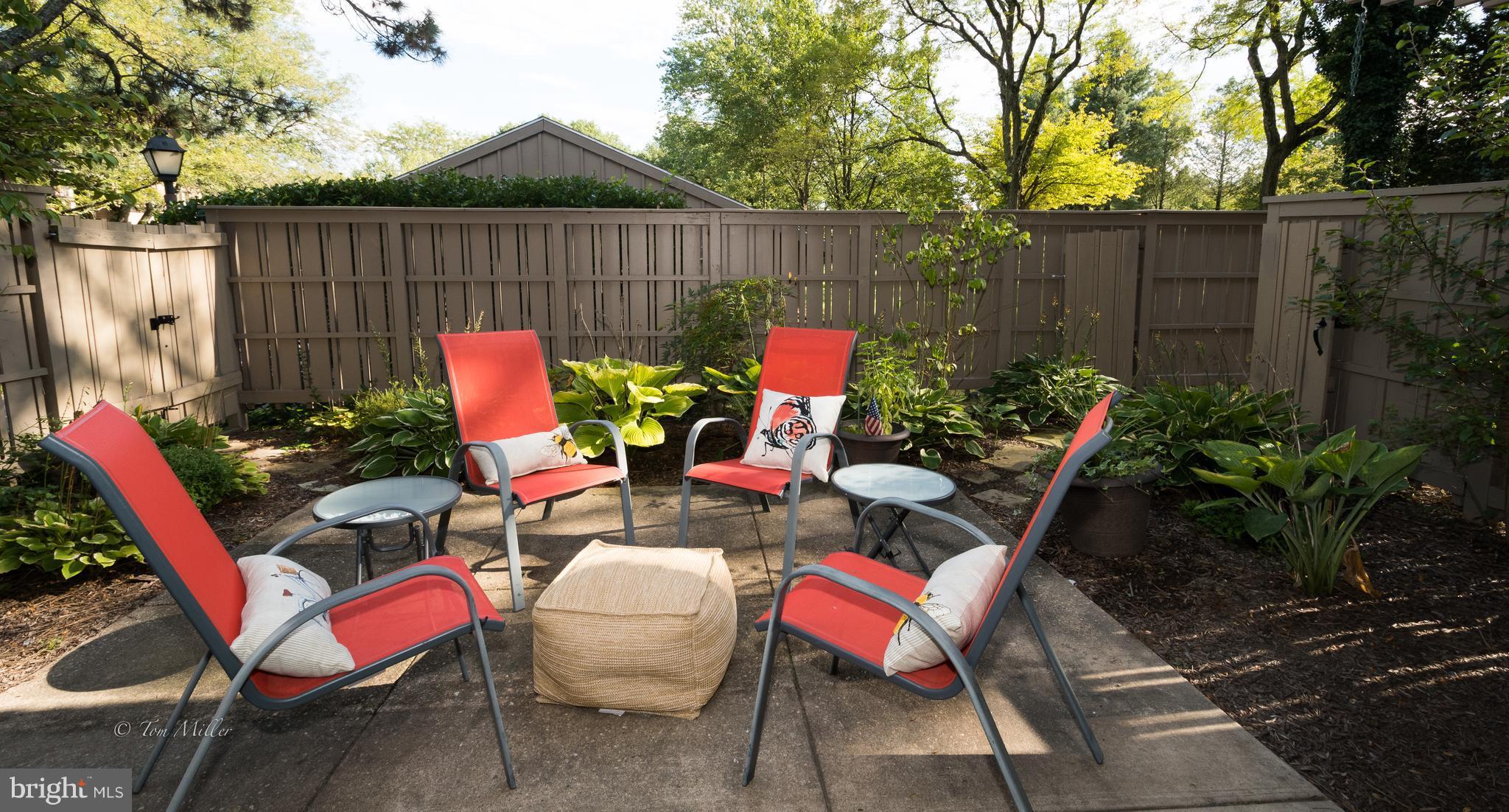 118 Cross Keys Road, Unit R118A Baltimore, MD 21210 - Photo 17 of 20 a backyard of a house with dining table and chairs with plants
