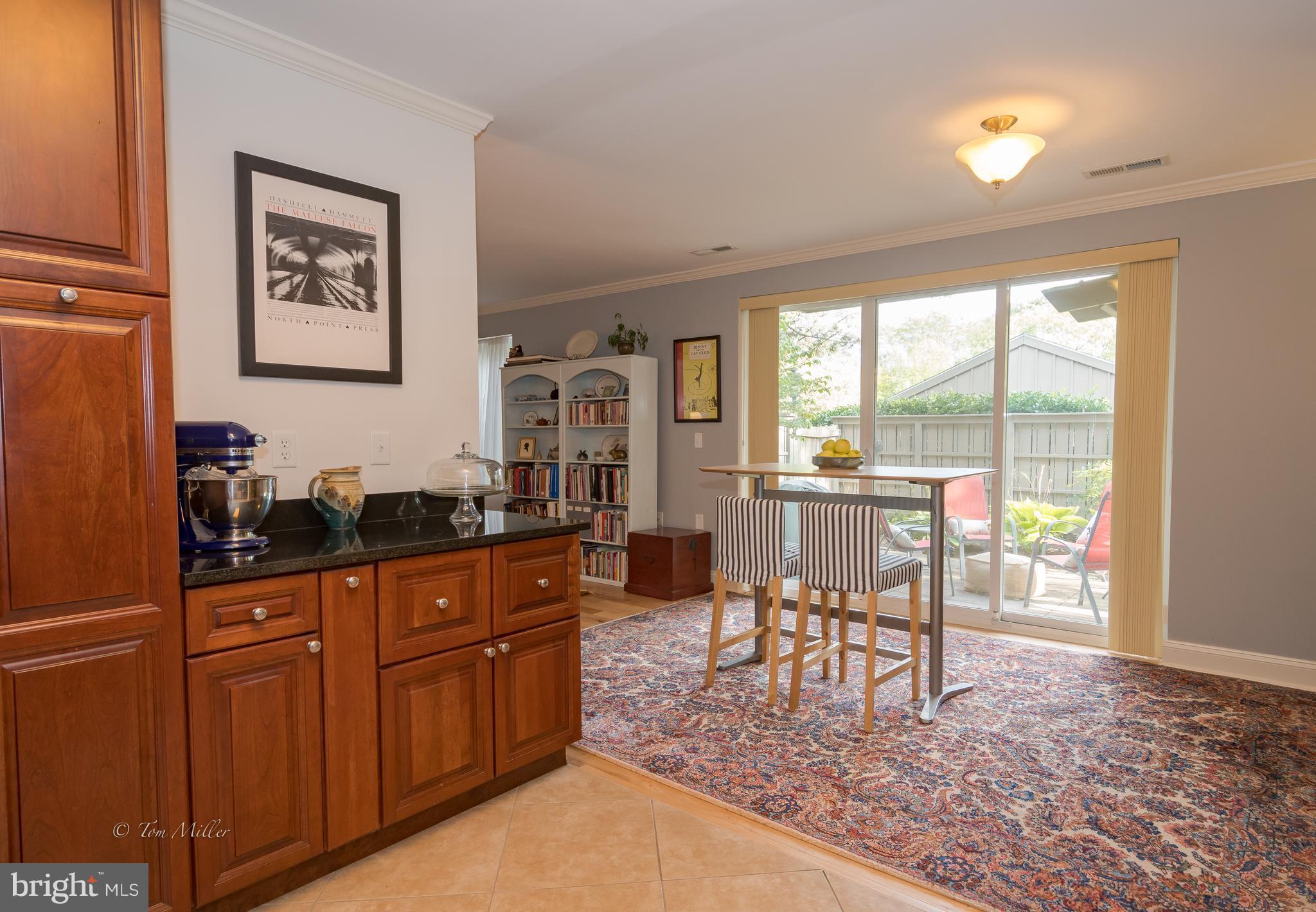 118 Cross Keys Road, Unit R118A Baltimore, MD 21210 - Photo 6 of 20 a dining room with wooden floor and large windows