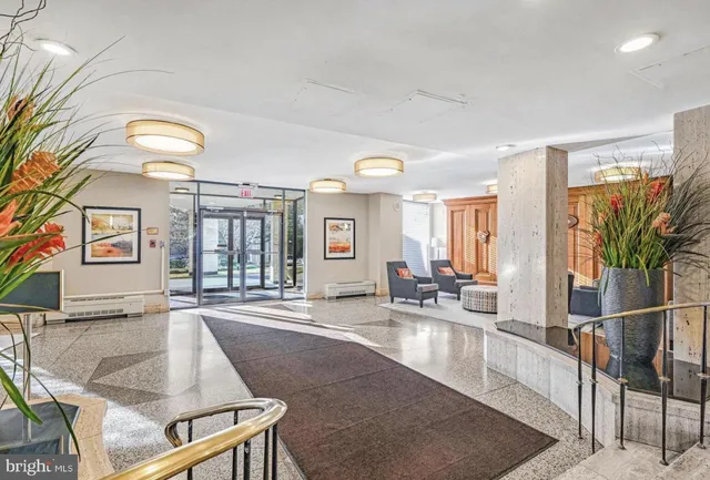 a living room with couches a dining table and chairs with outer view