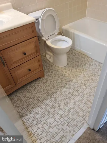 a bathroom with a sink a toilet and bathtub