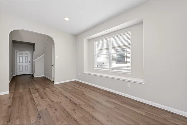 a kitchen with stainless steel appliances granite countertop wooden cabinets a stove top oven a sink and dishwasher a refrigerator with wooden floor