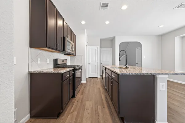 a view of a room with wooden floor and windows