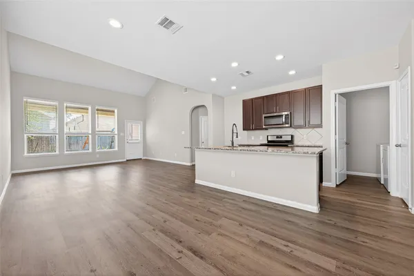 a view of kitchen and hall with wooden floor