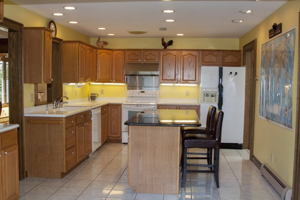 1170 Florence Road Northampton, MA 01062 - Photo 14 of 25 a kitchen with a refrigerator a sink and chairs