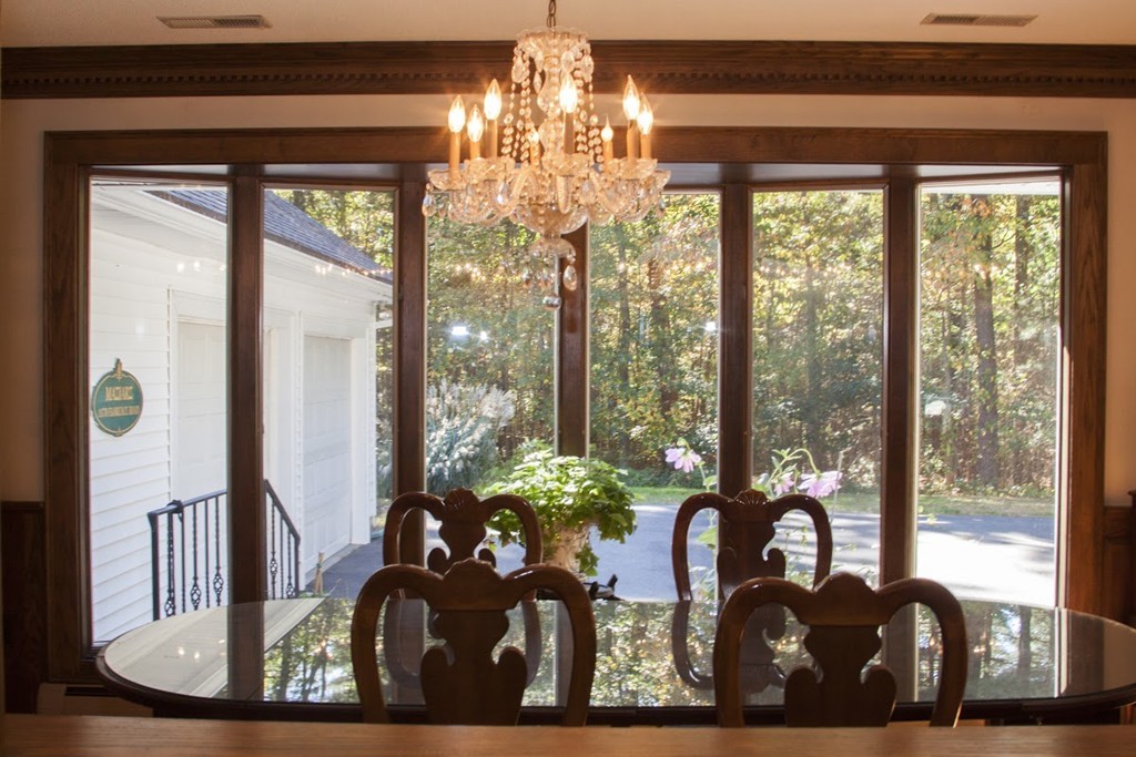 1170 Florence Road Northampton, MA 01062 - Photo 18 of 25 a view of a dining room with furniture large windows and wooden floor