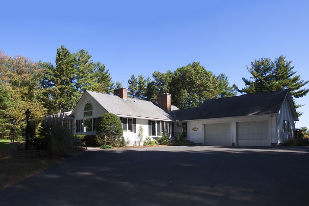 1170 Florence Road Northampton, MA 01062 - Photo 2 of 25 a front view of a house with a garden and trees