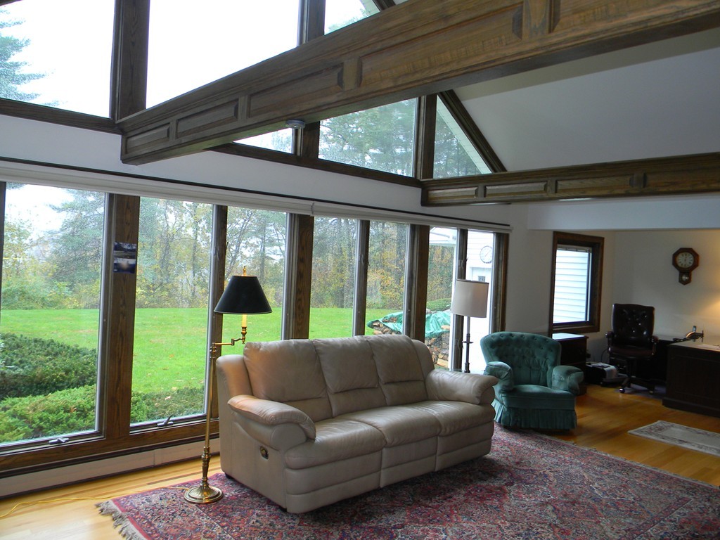 1170 Florence Road Northampton, MA 01062 - Photo 10 of 25 a living room with furniture and a floor to ceiling window